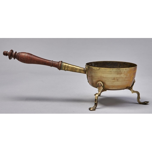1219 - A brass chafing dish, 18th c, the three shaped legs each secured by three rivets, turned pearwood ha... 