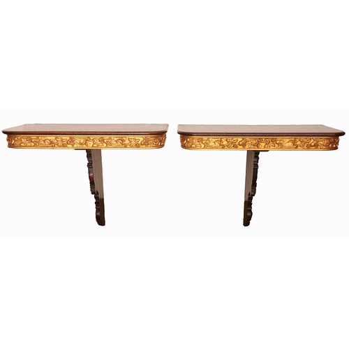 2011 - A pair of parcel gilt mahogany console tables, 20th c incorporating 19th c elements, with crisply ca... 