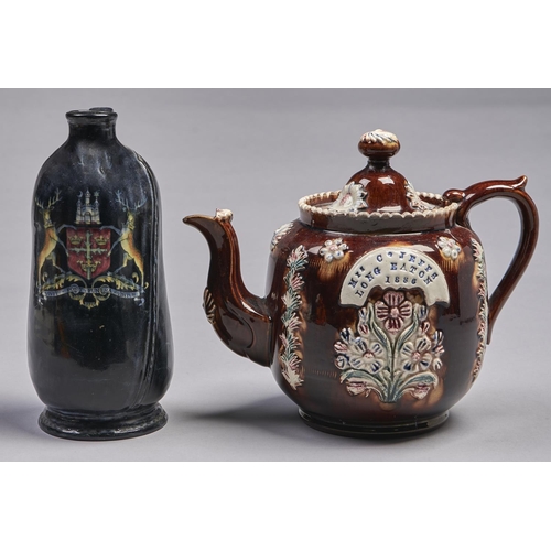 472 - A barge ware teapot, 1886, with polychrome floral sprigs and impressed on a banner in printer's type... 