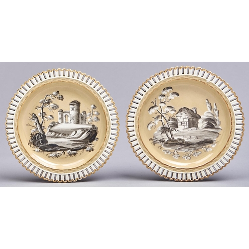 550 - A pair of Staffordshire buff ground pearlware arcaded plates, c1820, painted en grisaille with ruins... 
