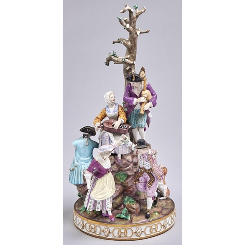 559 - A Meissen group, c1870, of six merrymakers playing music, dancing or eating and drinking on rocks be... 