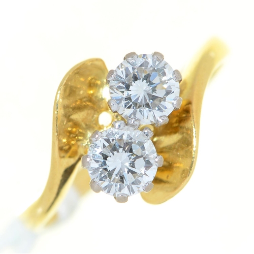 8 - A diamond crossover ring,  with round brilliant cut diamonds, in 18ct gold, London 1988, 3g, si... 