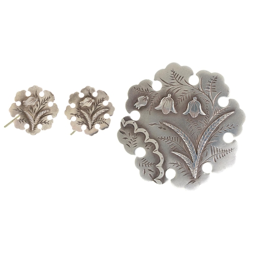 31 - A Victorian silver brooch and pair of earrings en suite, with applied floral decoration, brooch 38mm... 