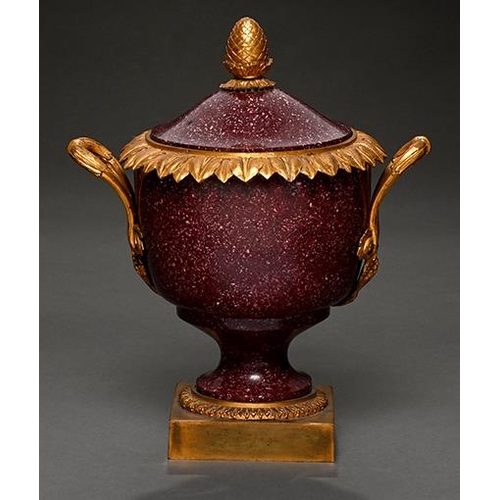 510 - A French ormolu mounted porphyry urn and cover, 19th c, with overlapping acanthus leaf rim and pinea... 