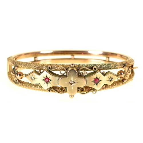 54 - An Edwardian ruby and diamond bangle, in 9ct gold, gypsy set, part marked and applied Rd No, 10.2g... 