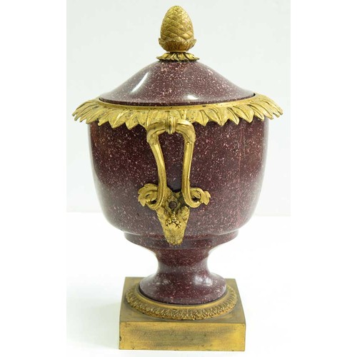 510 - A French ormolu mounted porphyry urn and cover, 19th c, with overlapping acanthus leaf rim and pinea... 