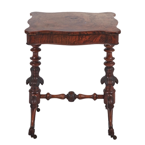 17 - A Victorian serpentine walnut work table, the lid in figured veneers and lifting to reveal a sycamor... 