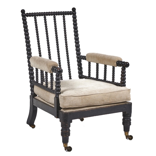 2 - A George IV bobbin turned and ebonised open armchair, with padded arms, brass castors, seat height 3... 