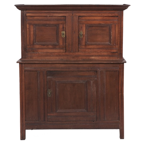 31 - A Charles II oak livery cupboard, the ogee cornice above panelled doors and projecting base, enclose... 