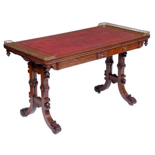 40 - An early Victorian Elizabethan oak writing table, the leather inlet oblong top with pierced brass ga... 