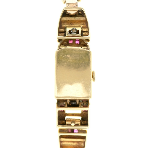 546 - Dorothy Squires' wristwatch. A mid-century ruby, diamond and 14ct gold cocktail watch, the rectangul... 