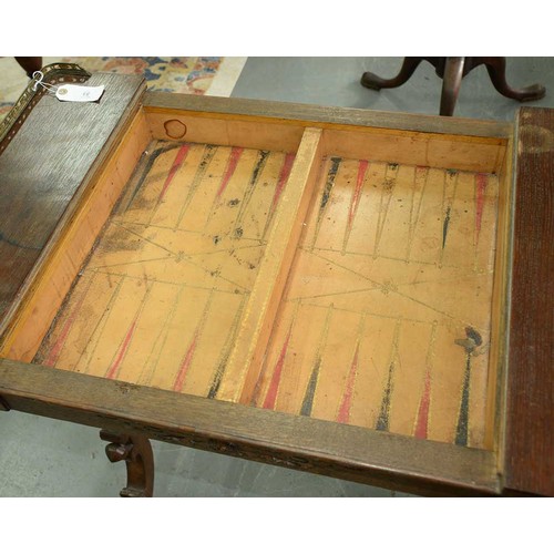 33 - An early Victorian Elizabethan oak games table, the oblong top with brass end-galleries, the reversi... 