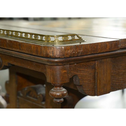 33 - An early Victorian Elizabethan oak games table, the oblong top with brass end-galleries, the reversi... 