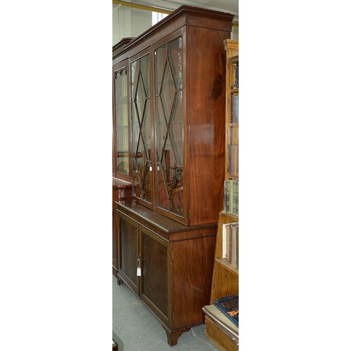 25 - A mahogany bookcase, early 19th c, with stepped cornice and figured frieze, fitted with adjustable s... 
