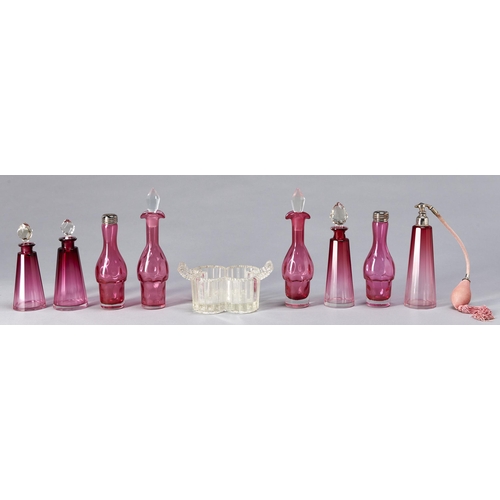 12 - A Victorian press moulded glass and cranberry glass cruet, with plated covers or faceted stoppers, 2... 