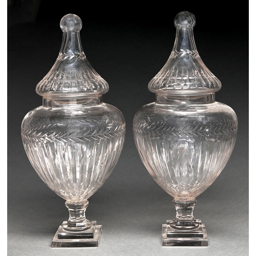 49 - A pair of shield shaped cut glass vases and covers, 20th c, on stepped square foot, 54cm h... 