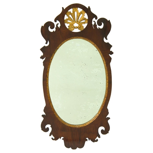 634 - A parcel gilt walnut fretted frame mirror, 19th / early 20th c, with oval plate, 75cm h... 