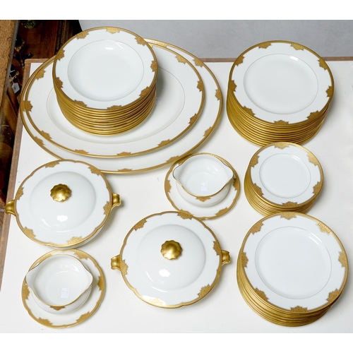 450 - A Limoges white and gold dinner service, second quarter 20th c, largest dish 51cm l, printed marks, ... 