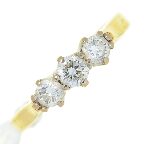 6 - A three stone diamond ring, in gold, marked DIA .50 18CT, 3.2g, size J