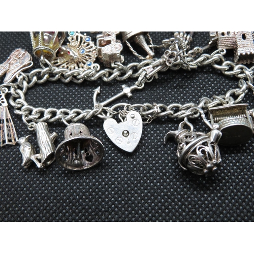 33 - Vintage silver charm bracelet with 15 charms London 1979 62g