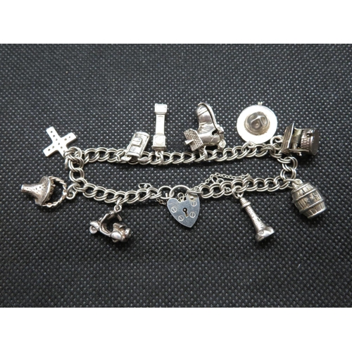 37 - Silver charm bracelet with 10x charms London 1986 26.5g