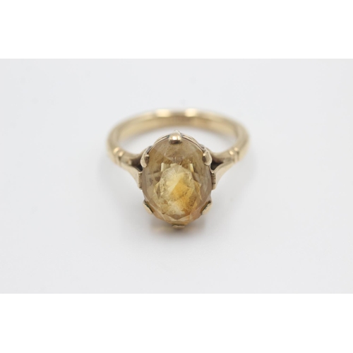 34 - 9ct gold oval cut citrine claw framed ring (4.4g) Size M
