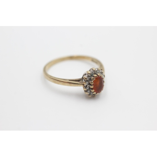 37 - 9ct gold diamond framed fire opal ring (2.4g) size P
