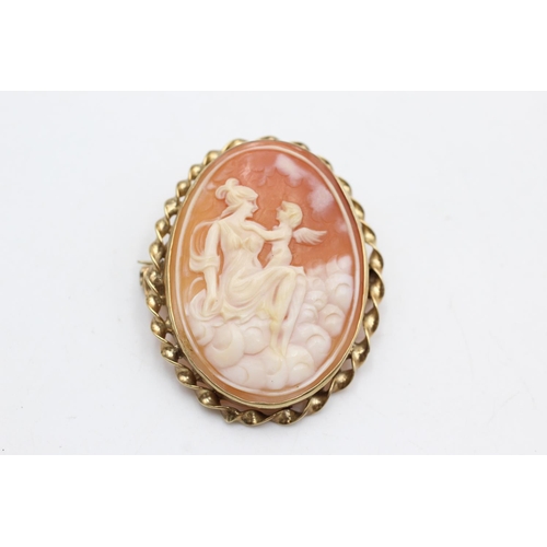 31 - 9ct gold framed shell cameo featuring woman & a cherub (9.8g)