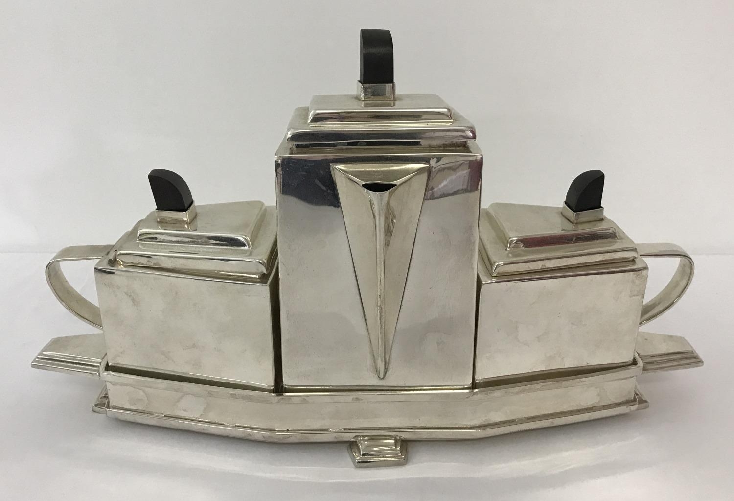 An Art Deco style 4 piece silver plated tea set. Comprising teapot, milk jug and sugar bowl with wo
