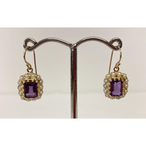 12 - A pair of 9ct gold amethyst and seed pearl earrings in a drop style.  Emerald cut amethysts surround... 