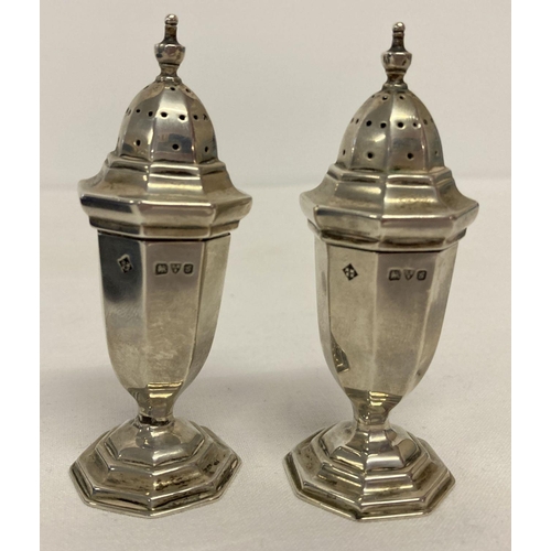 378 - A boxed pair of Edwardian silver pepperettes, hallmarked Chester 1907.  Octagonal shaped bodies rais... 