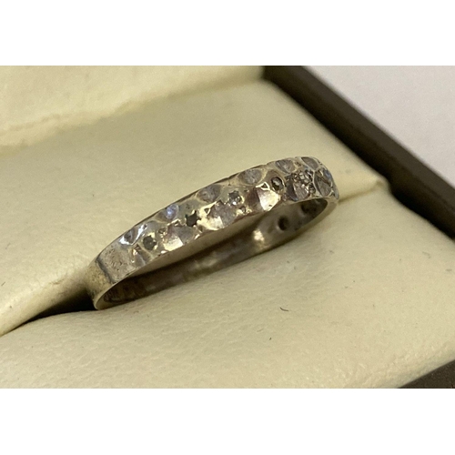 52 - A vintage 9ct white gold eternity style ring set with small diamonds.  Setting for 10 stones, 2 miss... 