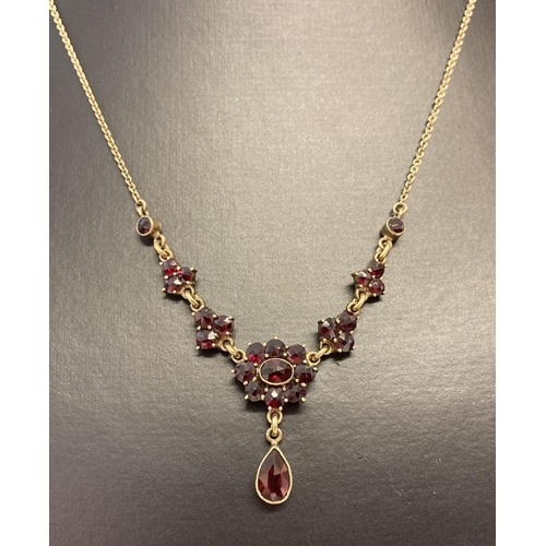 9 - An antique Edwardian Norm Gold and garnet set necklace.  Floral design cluster style fixed pendant w... 