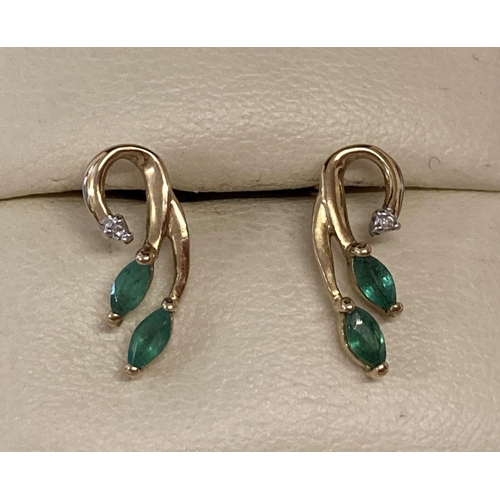 1003 - A pair of 9ct gold emerald and diamond set floral design earrings. Each earring set with 2 small mar... 