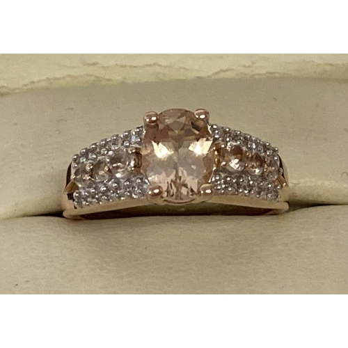 1007 - A boxed rose gold plated silver dress ring set with morganite and clear stones, by Danbury Mint. Cen... 