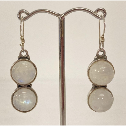 1012 - A pair of modern design silver drop earrings set with round cabochon moonstones. 925 mark to back of... 
