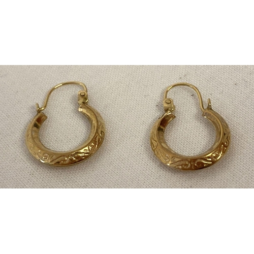 1016 - A small pair of creole style gold earrings with floral decoration. Tests as 9ct gold. Each earring a... 
