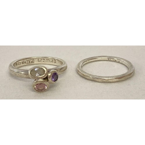1021 - 2 silver stacking rings by Truth. A silver band with diamond shaped detail and a dress ring set with... 