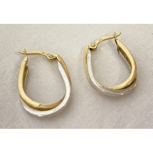 1029 - A pair of 9ct white and yellow gold intertwined hoop style earrings. Posts marked 375. Each earring ... 