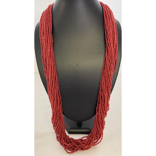1058 - A multi strand coral chip necklace with silver tone hook and eye claps.  Total length approx. 30 inc... 