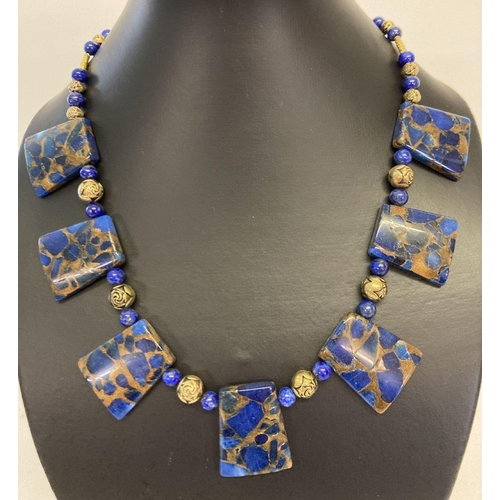 1059 - A boxed lapis Lazuli and gold tone bead Cleopatra style necklace with gold tone S shaped clasp.