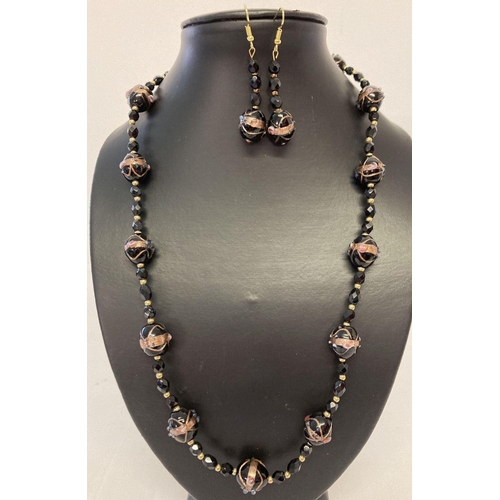 1061 - A matching necklace and earrings set made with black Venetian style glass beads. Necklace with gold ... 