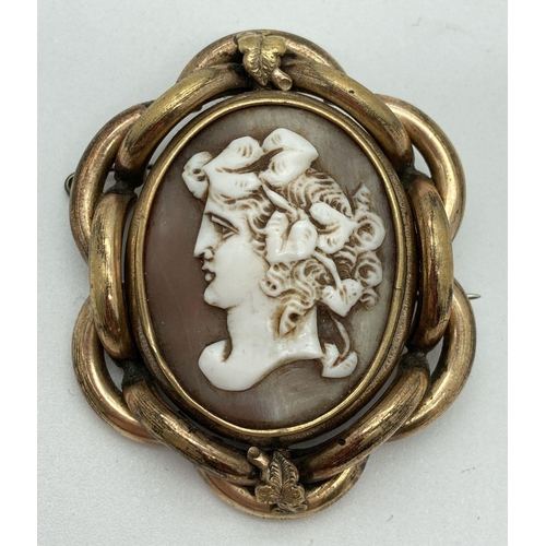 A large Victorian mourning brooch with rotating central panel and pinchbeck mount. Swivel panel features a classical style cameo to one side and with a glazed panel to reverse for holding a loved one's lock of hair. Complete with safety chain with pin fastener, pin back and hook clasp. Approx. 5.5cm x 4.5cm.