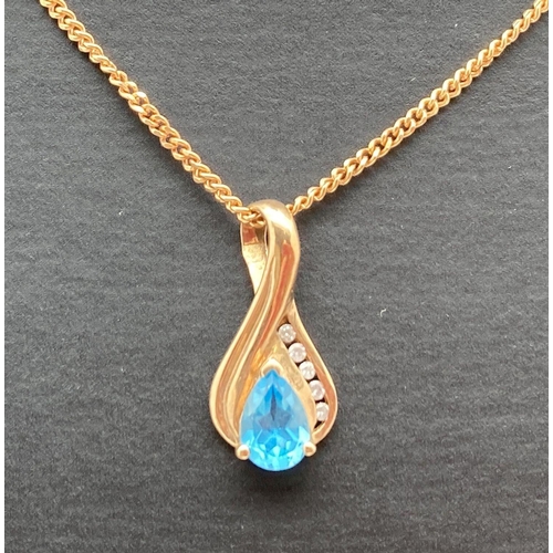 A 9ct gold drop pendant set with a teardrop cut blue topaz and 5 small round cut diamonds, on an 18" 9ct gold fine curb chain with spring clasp. Both back of pendant and fixings to chain fully hallmarked. Total weight approx. 4.1g. Pendant 2cm drop.