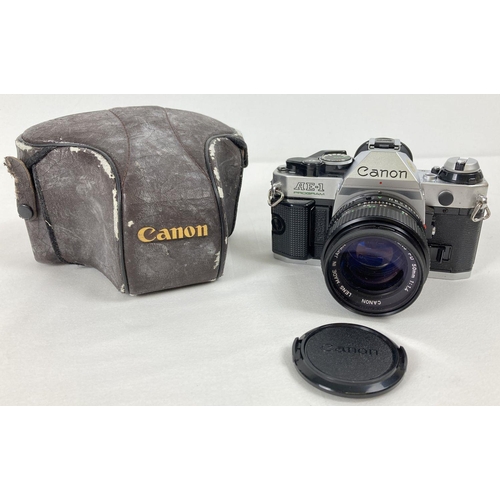 1212 - A Canon AE-1 Program camera with Hoya Skylight Canon Lens FD 50mm 1:1.4 and cover case. The cover ca... 