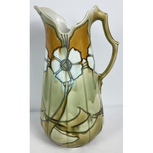 A large Art Nouveau floral design, No.12 water jug by Minton. In green and amber brown glaze. Marks to base. Approx. 38cm tall.