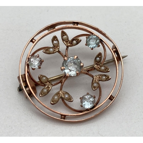 2 - A Edwardian 9ct gold circular shaped pin back brooch with floral detail. Set with seed pearl and 4 a... 