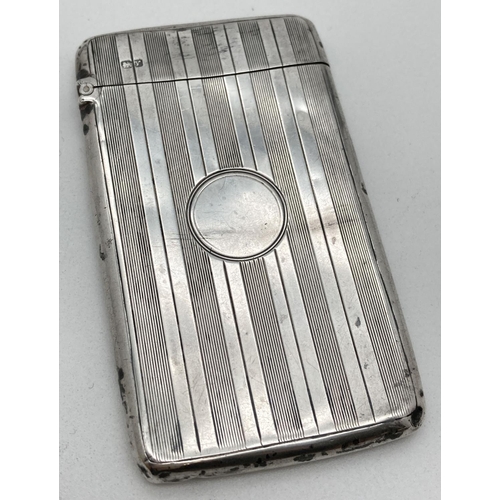 1060 - An Art Deco silver card case with engine turned design front and back. Features a blank circular car... 
