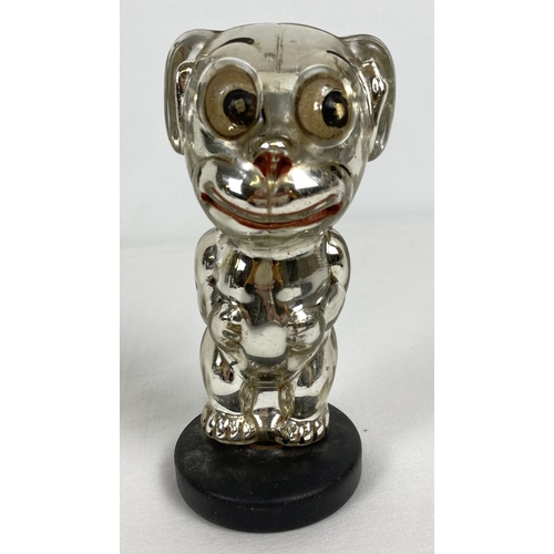 A vintage 1930's Bonzo dog, novelty silver glass perfume bottle with Painted eyes, mouth and claws. Approx. 14cm tall.