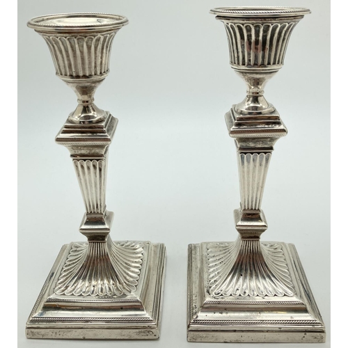 1182 - A pair of William Hutton & Sons, Victorian Silver candlesticks of classical form. Both hallmarked to... 